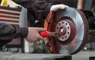 repairing a car brake disc with a wrench in an auto repair workshop in Marsden Park NSW