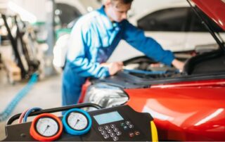 Mechanic performing brake pad and rotor replacement on a vehicle